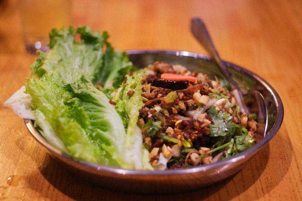 Naem+khao+thadeau%2C+or+crispy+coconut+rice%2C+is+made+up+of+sour+pork%2C+roasted+peanuts%2C+banana+blossoms%2C+lime%2C+scallions+and+cilantro.+