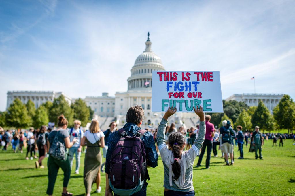 Protesters with Fridays for Future demonstrate outside of the U.S. Capitol building Friday.