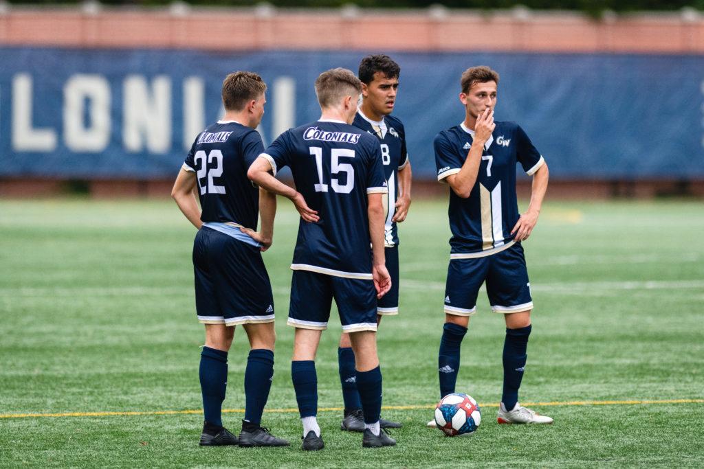 The men's soccer team discusses strategy during a game. The team was the first to participate in a mental health training last week.