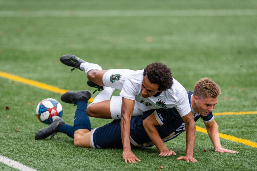 Brown forward Malcolm Johnson collides with graduate student midfielder/defender Sandro Weber during Saturdays game against Brown. The Colonials beat the Bears 2–0. 