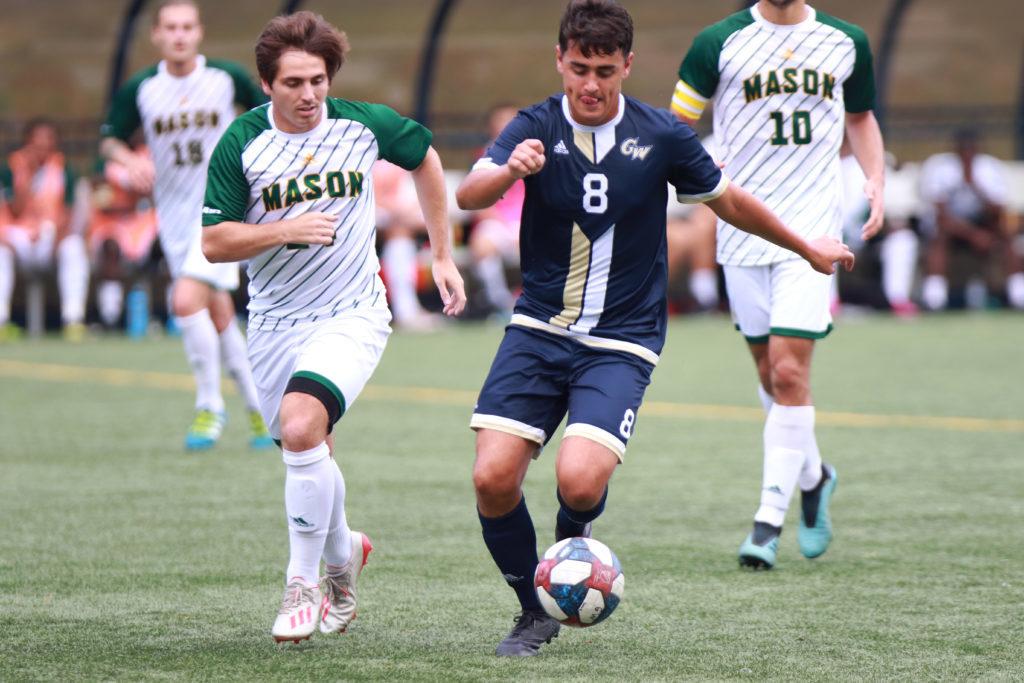 Senior midfielder Max Holdsworth runs with the ball Saturday in a game against George Mason. The Colonials fell to the Patriots 2–1. 