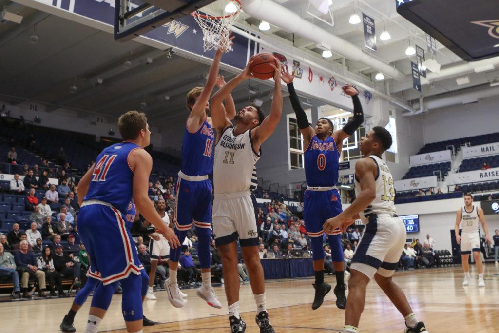 Senior forward Arnaldo Toro bodies his way to the basket against American, tying the Atlantic 10 single-game record for rebounds with 24 boards. The Colonials fell to the Eagles 67–65 after a nail-biting performance.  