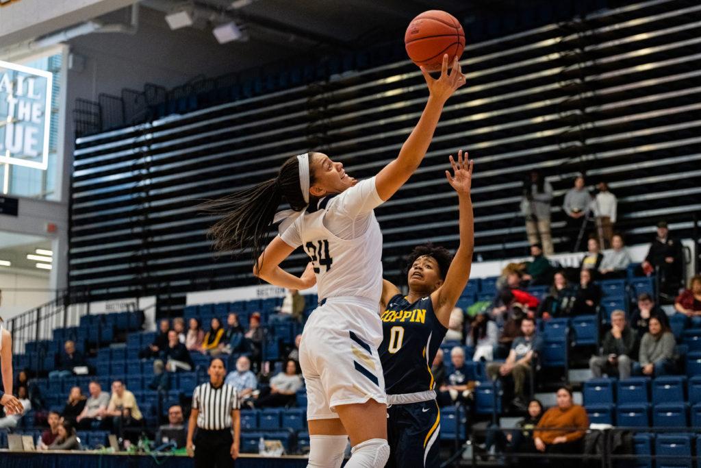 Sophomore center Kayla Mokwuah reaches for the ball in a game against Coppin State. In the Colonials matchup against American, Mokwuah led all scorers with a career-high 18 points.
