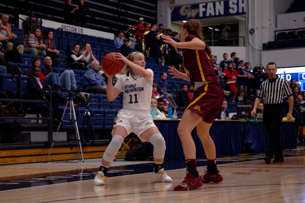 Redshirt freshman Tori Hyduke looks to dish the ball during a game against Minnesota. The Colonials fell to the Golden Gophers 83–50. 