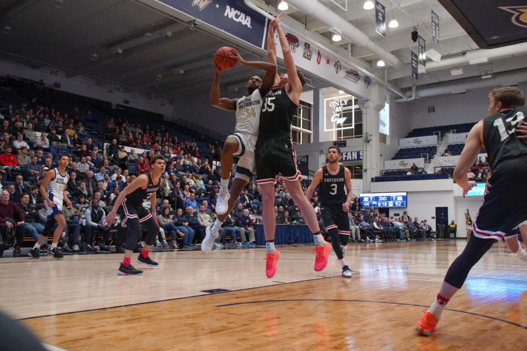 Junior guard Maceo Jack takes the ball to the hoop in Wednesdays quadruple overtime win against Davidson. The Colonials edged the Wildcats 107–104. 