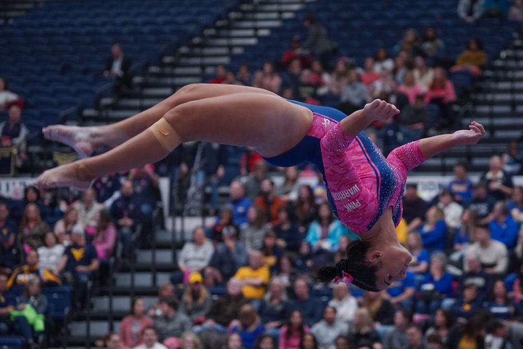 Senior Cydney Crasa flips on the beam. At the 2020 Pink Meet the Colonials placed No. 2 with 195.375 points. 