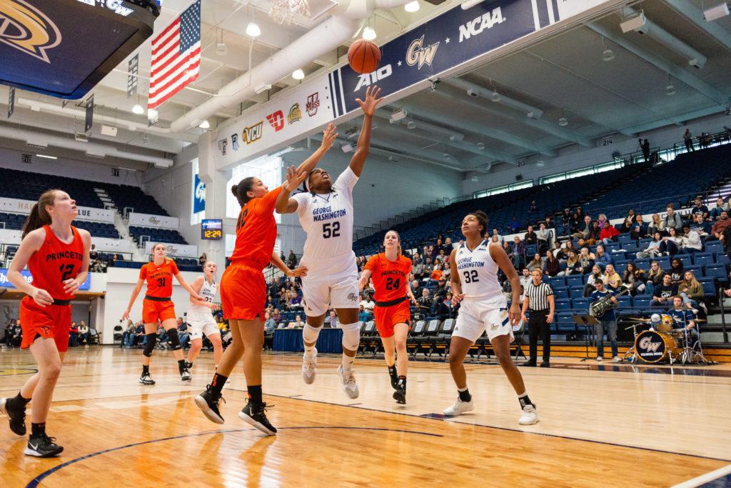 Graduate student forward Alexandra Maund leaps for the ball. In the Colonials win over Philadelphia, she reached a season-high 18 points and 10 rebounds. 