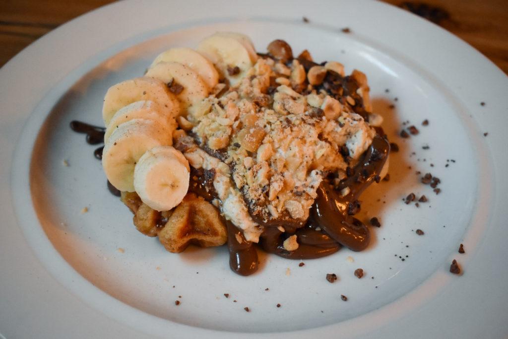 The Sovereign's nutella banana waffle is a decadent dessert topped with toasted hazelnuts and fresh banana. 
