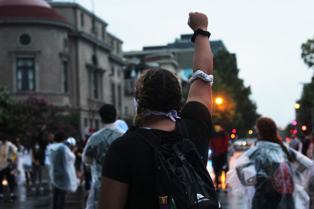 A+protester+raises+her+fist+during+an+Aug.+15+Black+Lives+Matter+march+organized+by+Theythem+Collective.