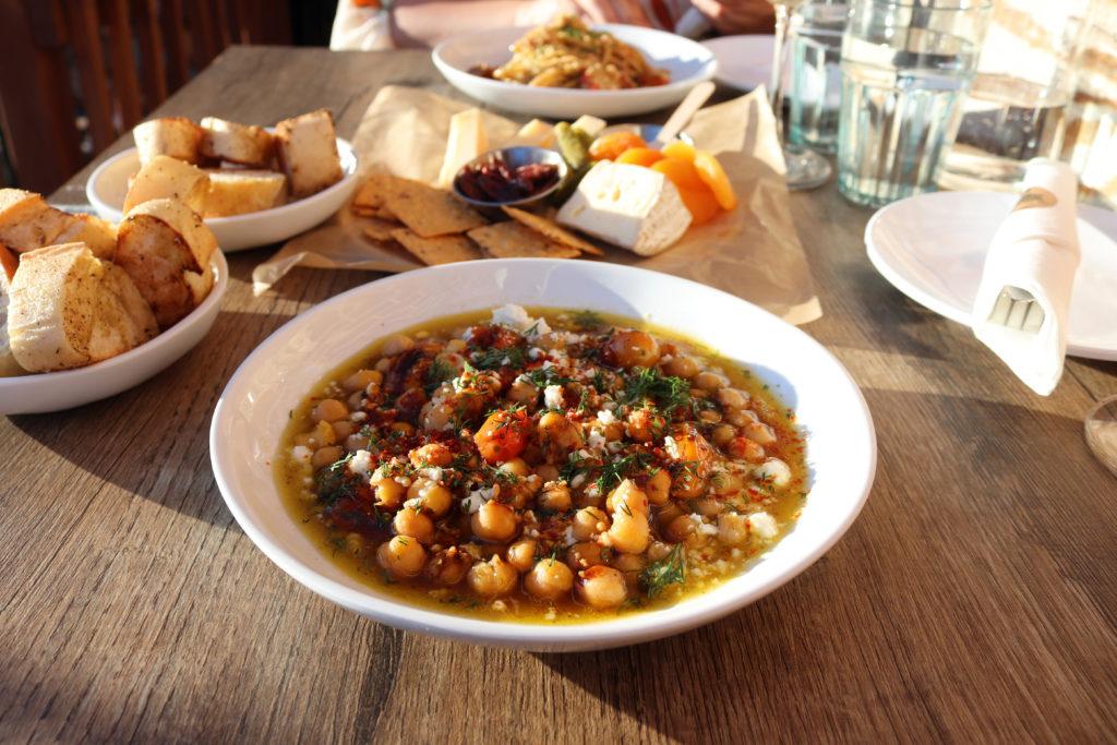 St. Vincent Wine's braised chickpeas are served in olive oil and topped with date molasses, fresh dill and crumbled feta.