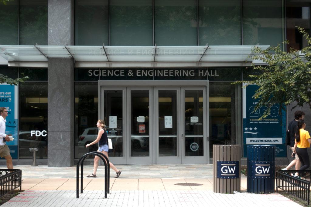 Students walk by the Science and Engineering Hall Sunday as they prepare for the return of in-person classes. 
