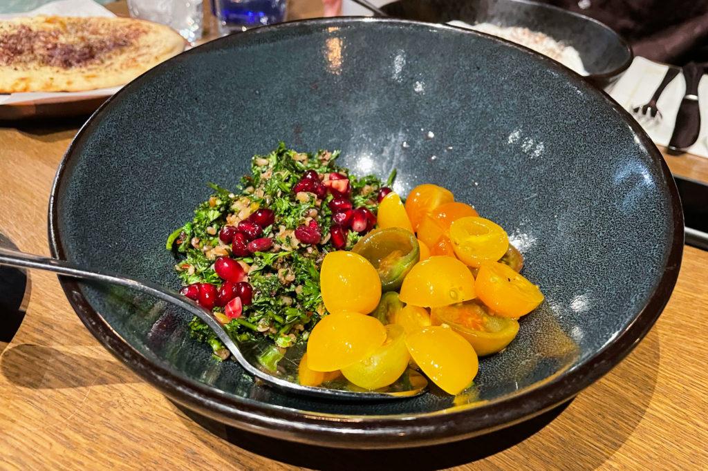 Ala’s freekeh tabbouleh is composed of red pomegranate seeds on top of a mix of parsley, fresh mint and freekeh, a grain derived from North African and Levantine cuisines. 