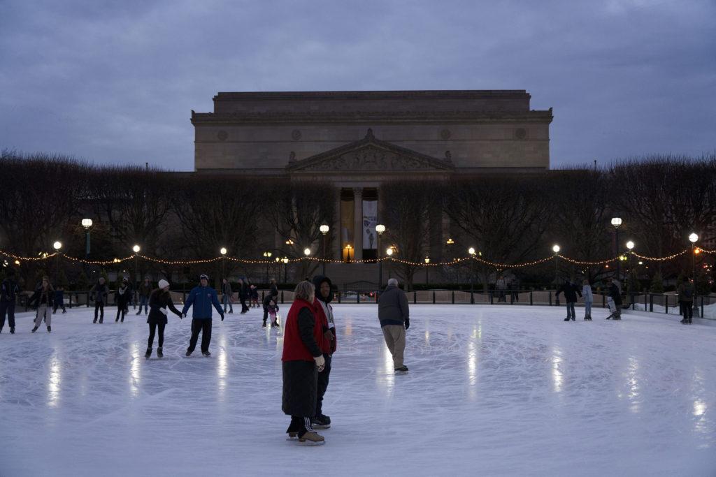 Skaters glide across the National Gallery of Art Sculpture Garden Ice Rink.