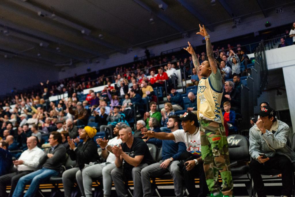 Swae Lee, wearing a Colonials jersey, cheered on the mens basketball team at a game in 2020.