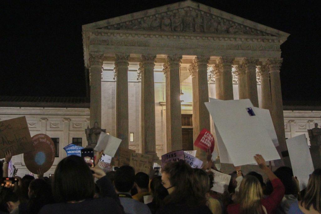 At least 500 people congregated outside the Supreme Court Monday night after a leaked draft majority opinion revealed the court voted to strike down Roe v. Wade, a move that would wipe away federal abortion protections.