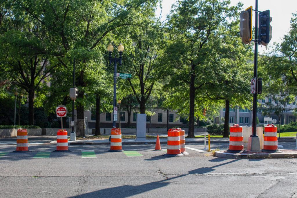 The barriers blocking the Virginia Avenue bike lane force cyclists to ride on the sidewalk or alongside traffic. 