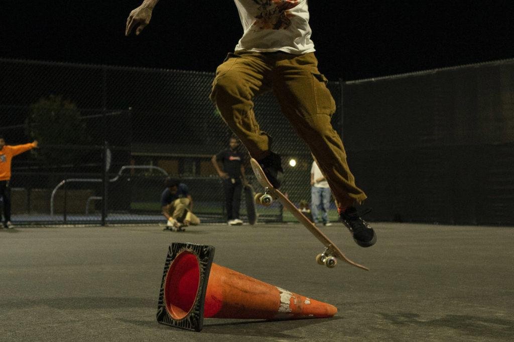 A skater does a trick over a traffic cone at Art All Night Friday. The event was sponsored by Bearings Mag, Expo DMV, Howard University Skate Club and Grind Stone Universal.