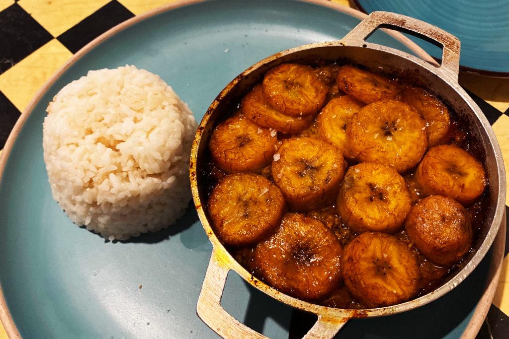 Qui Qui delves into classic Puerto Rican cuisine like fried plantain bites called tostones, bringing comfort during difficult times for those away from home.