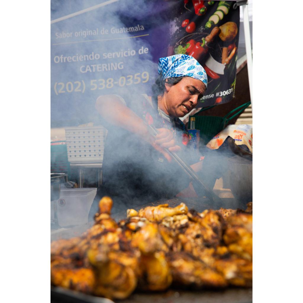 Nancia Sical owner of Nancias Antojitos grills chicken awaiting crowds from Fiesta DC on Sep. 26, 2022. This years festival spotlights Guatemalan culture, Nancias Antojitos prepares authentic Guatemalan food for the occasion.