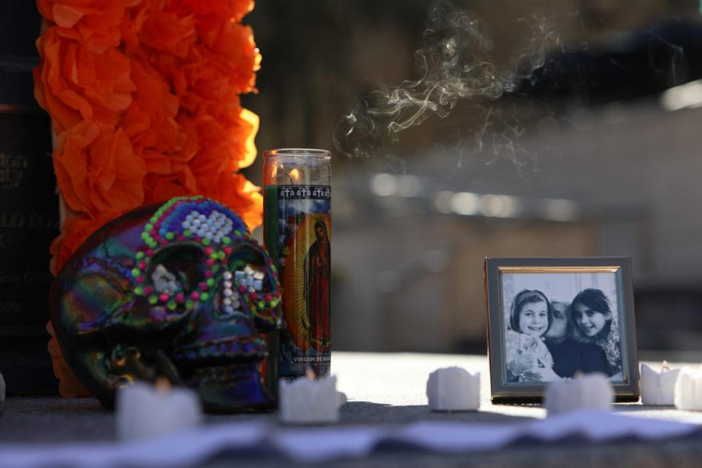 A bejeweled sugar skull, marigolds, candles and a student’s family photo decorates the Mexican Student Associations ofrenda, an altar that memorialized a person who has died as part of a Día De Los Muertos tradition.