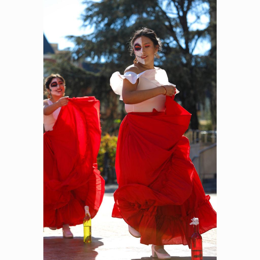 GW Folklorico members Melanie Don Juan, pictured left, and Bri Curi, pictured right, dance mid-performance in Kogan Plaza Saturday.