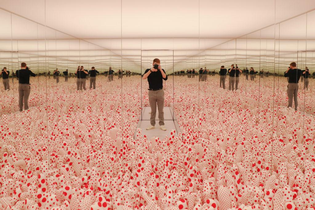 Mirrors surround a bed of colorful, artificial shrubbery to present an illusion of infinite depth at the Hirshhorn Museums permanent collection of work by contemporary artist Yayoi Kasuma.