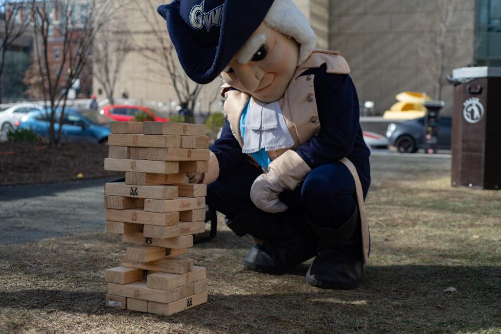 George plays a game of Jenga at the GW Palooza tailgate Sunday before attending the womens basketball homecoming game against George Mason.