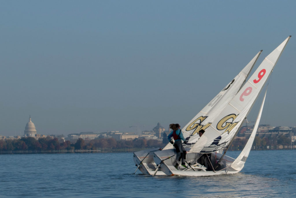 The+D.C.+skyline+paints+a+picturesque+backdrop+against+the+Potomac+River+as+GW+Sailing+sets+sail+for+an+early+morning+practice.