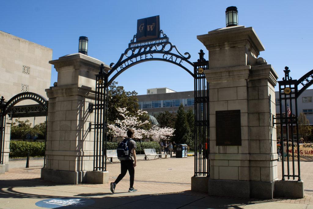 A student strolls through Kogan Plazas Trustees Gate on H Street.