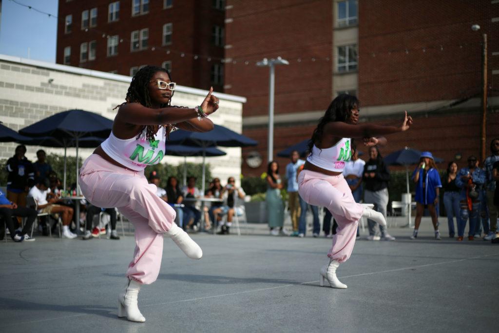 Two members of the Mu Delta Chapter of Alpha Kappa Alpha Sorority, Inc. perform for onlookers in Potomac Square at the NPHCs Yard Show and Cook Out event in late April.