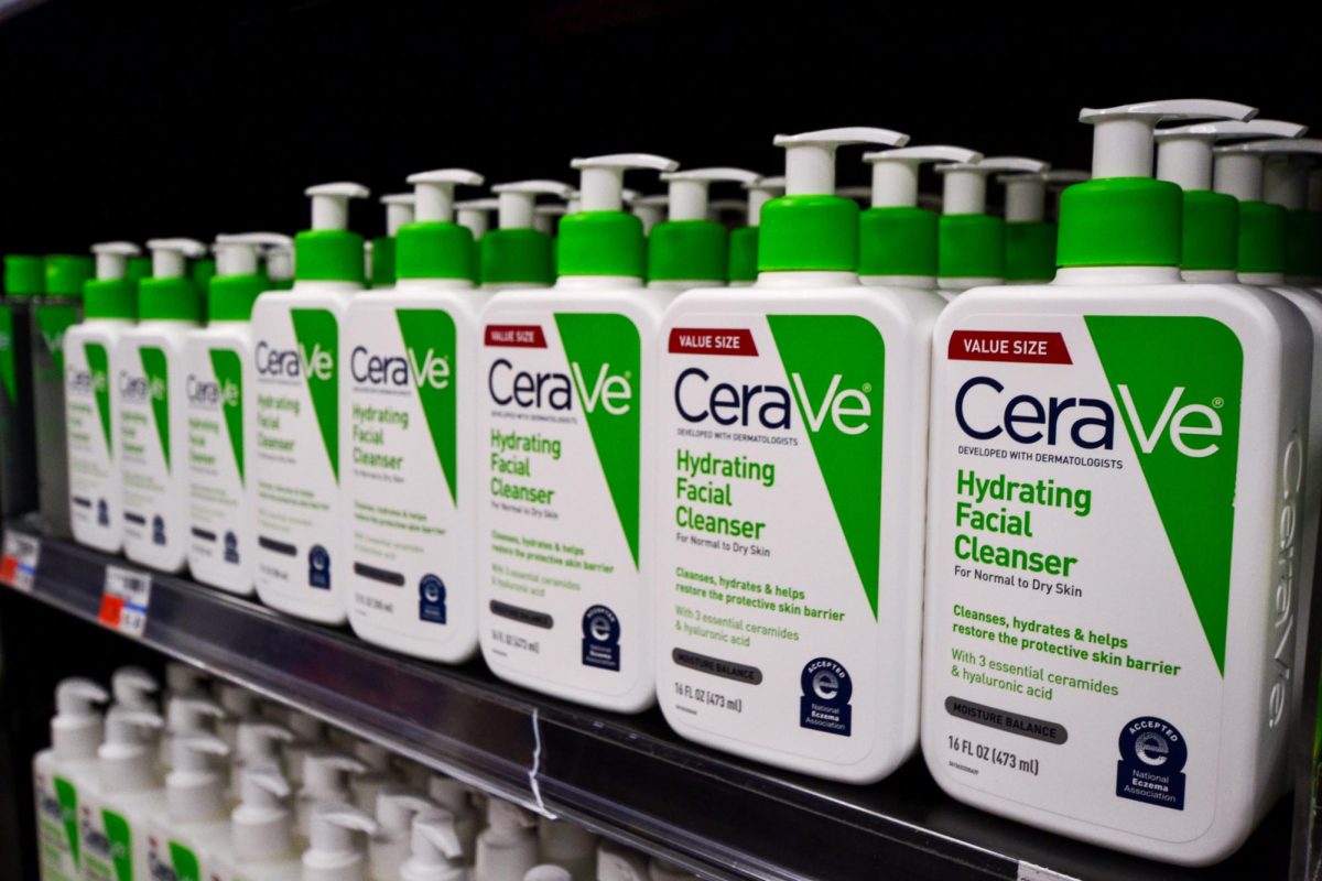 Bottles of CeraVe facial cleanser line the shelves in CVS.