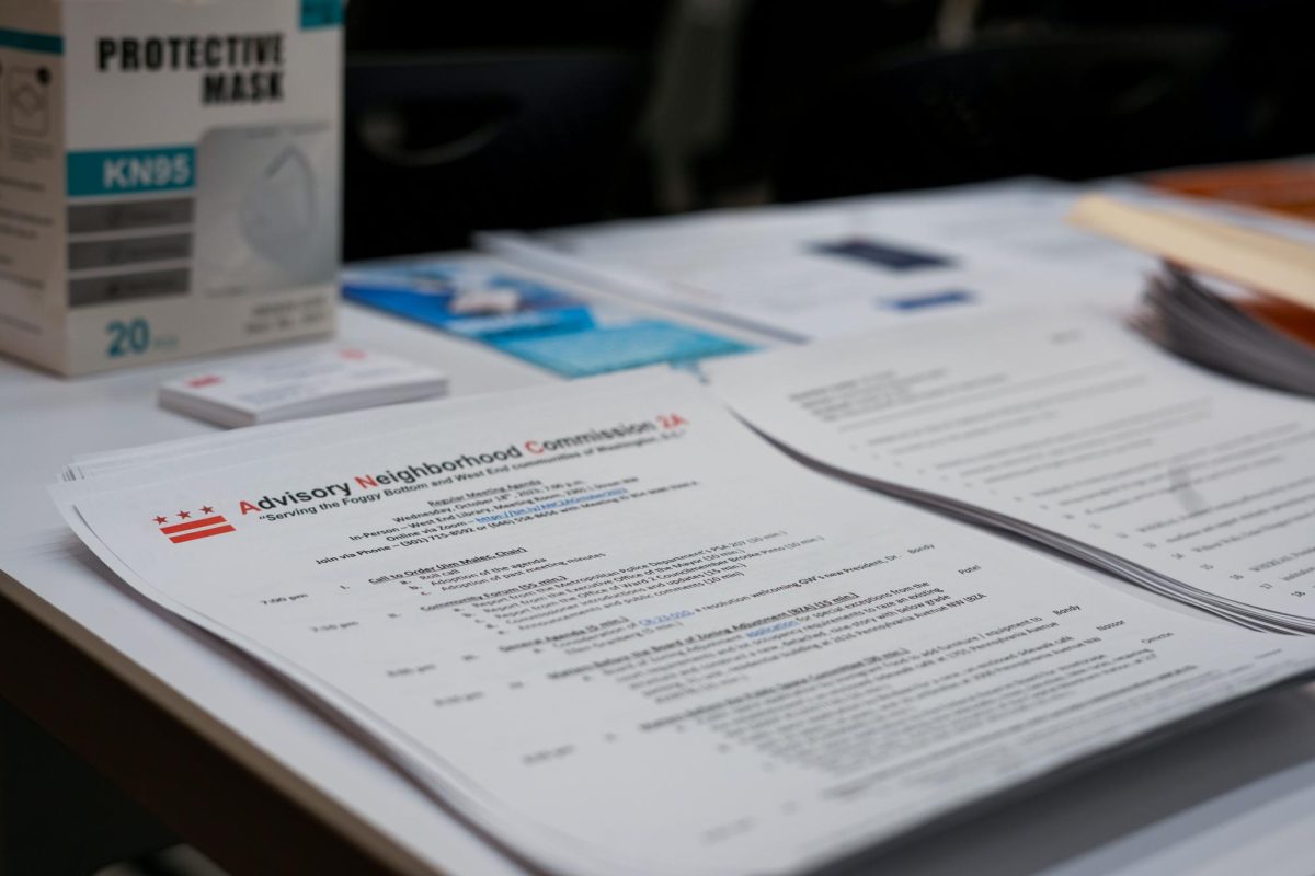 A Foggy Bottom and West End Advisory Neighborhood Commission meeting agenda sits on a table. 