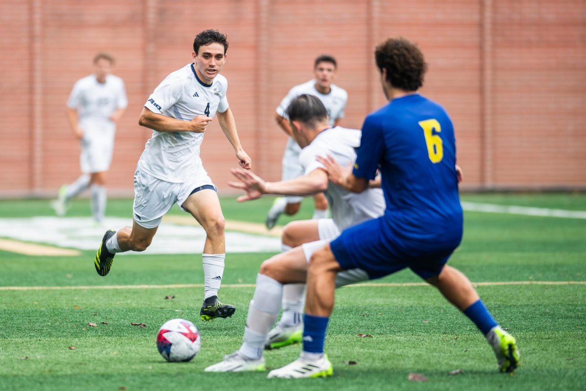 Graduate student midfielder William Turner chases after the ball in a match against Delaware in early October.