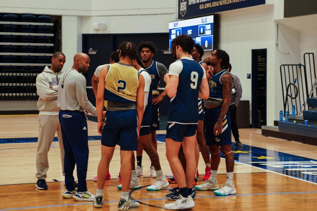 The mens basketball team huddles with coaches during a practice this semester.