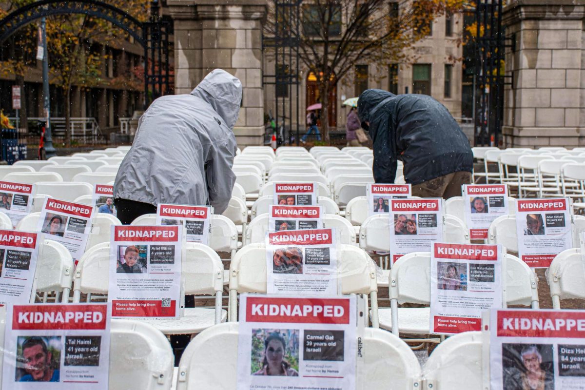 In Kogan Plaza, individuals set up empty chairs with signs depicting the hundreds of Israelis taken hostage by Hamas.