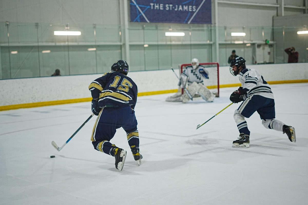 Senior forward Ethan Redden glides across the ice during the match against Georgetown.