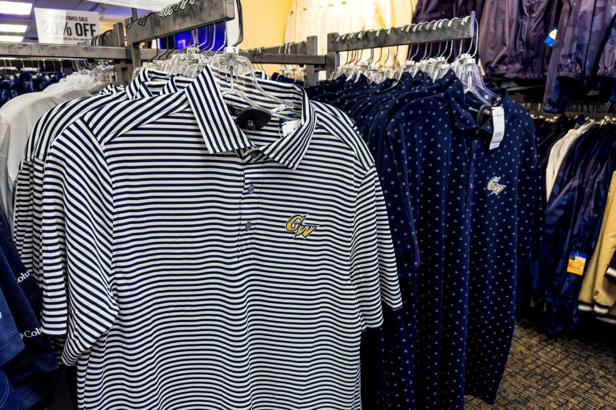 GW-branded polo shirts hang in the Campus Store in the University Student Center basement. 