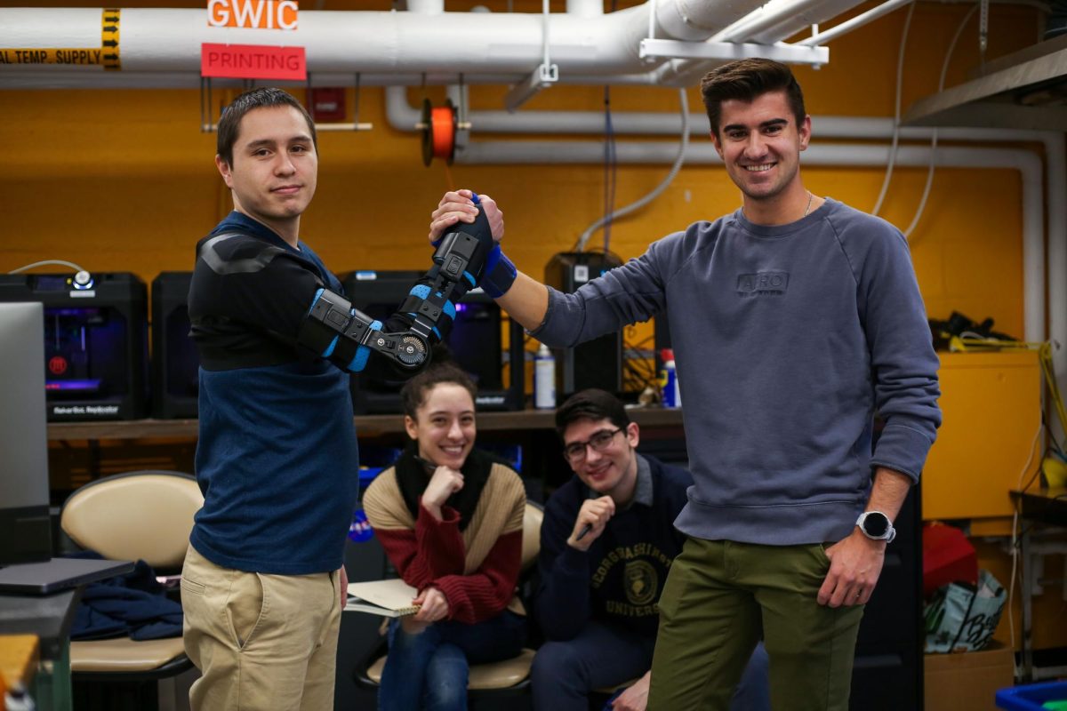 GW Engineering students demonstrate an arm brace designed for veteran and Paralympic athlete Robbie Gaupp.