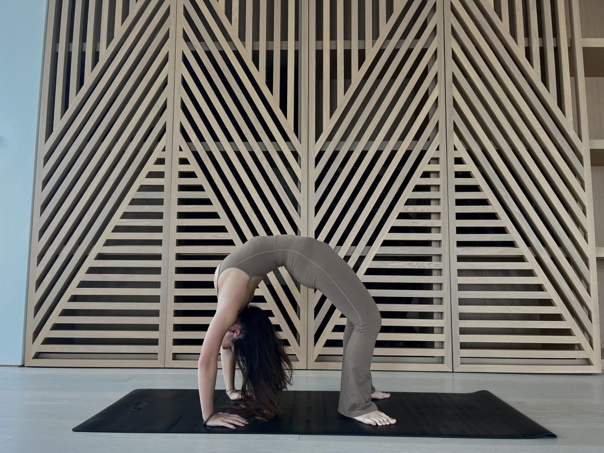 A yogi bends over backwards at Alo Yoga.