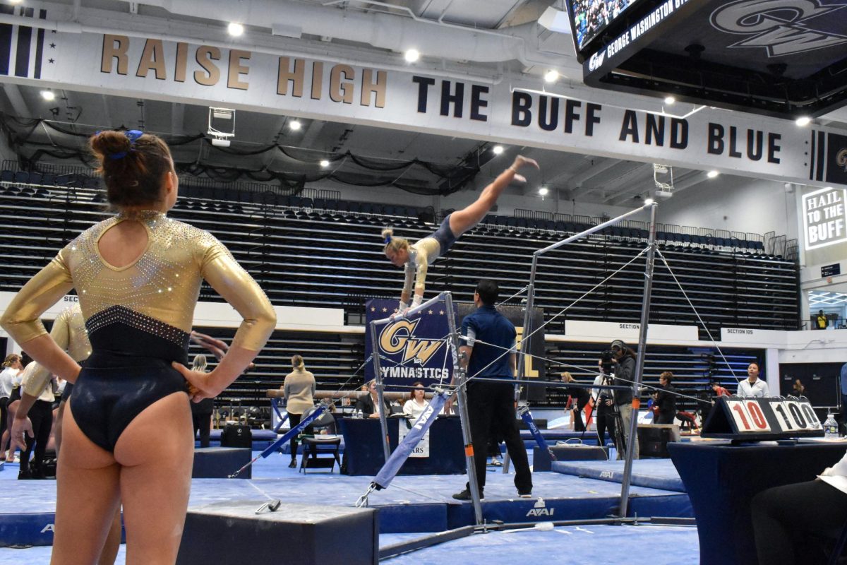 A Revs gymnast swings over the bar during the second meet of the year.