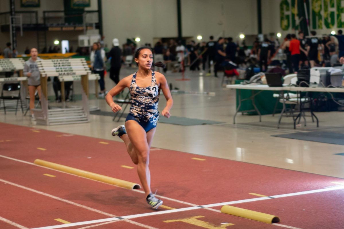 Sophomore Rita Mazumder crosses the finish line at a meet at George Mason.