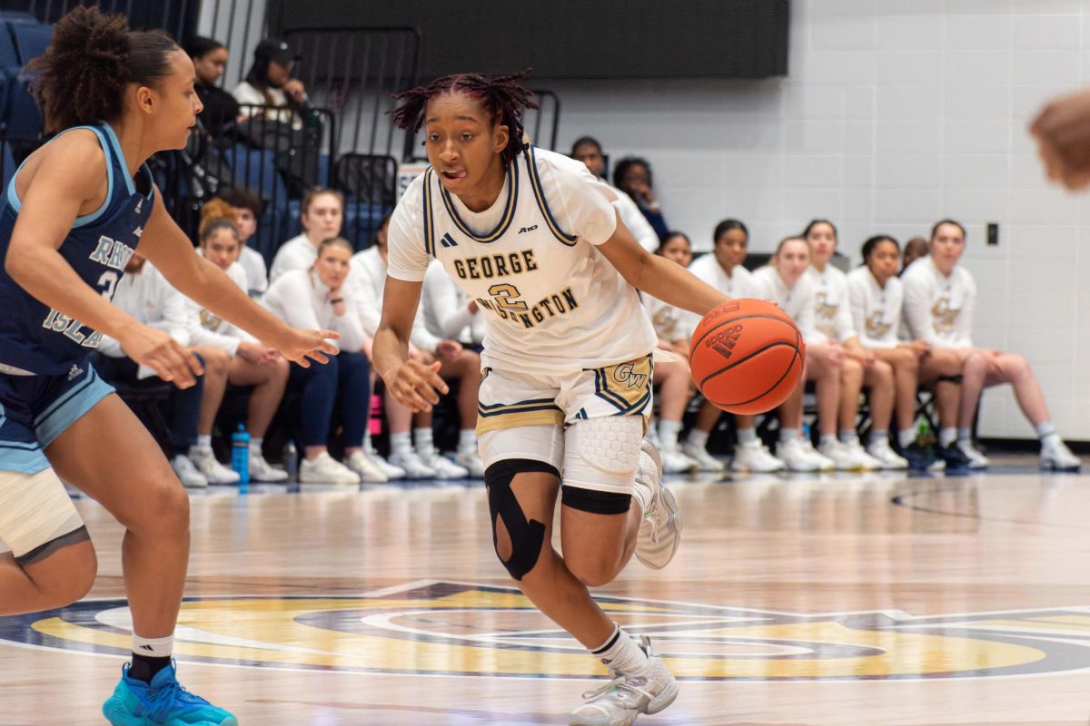 Sophomore guard Nya Robertson dribbles to the basket against a Rhode Island defender