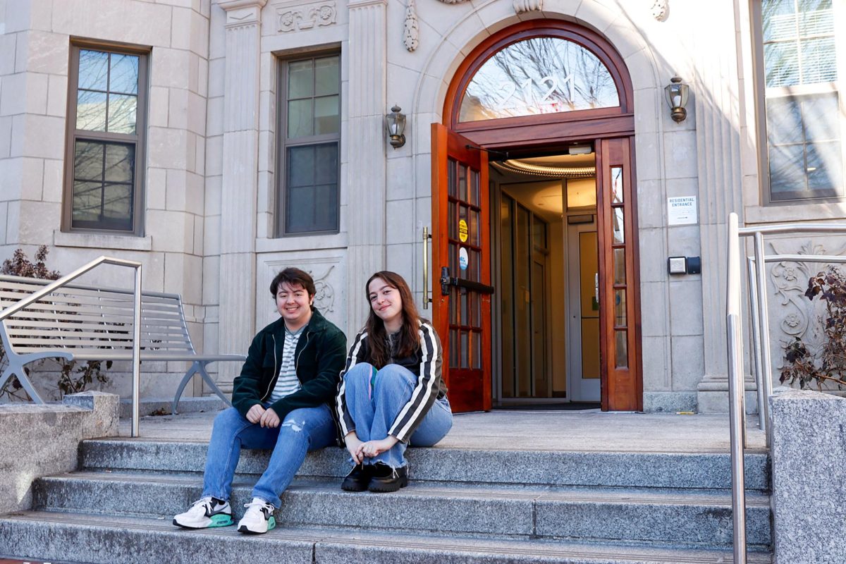 SGA Deputy Secretary of Student Justice Carson Consiglio and SGA President Arielle Geismar sit on the steps of District House, which will soon offer housing for transgender and nonbinary students.