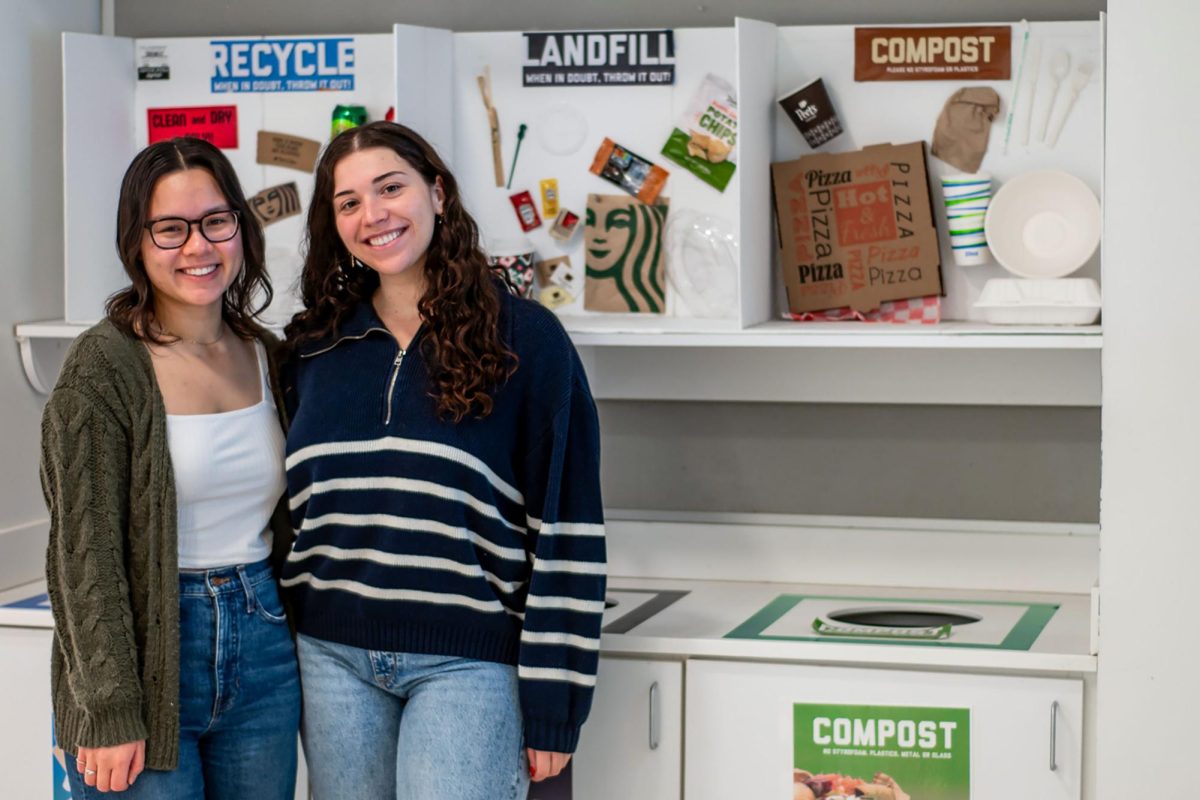Caylee Chan, left, and Hannah Silber, right, pose with their newly adorned composting station.