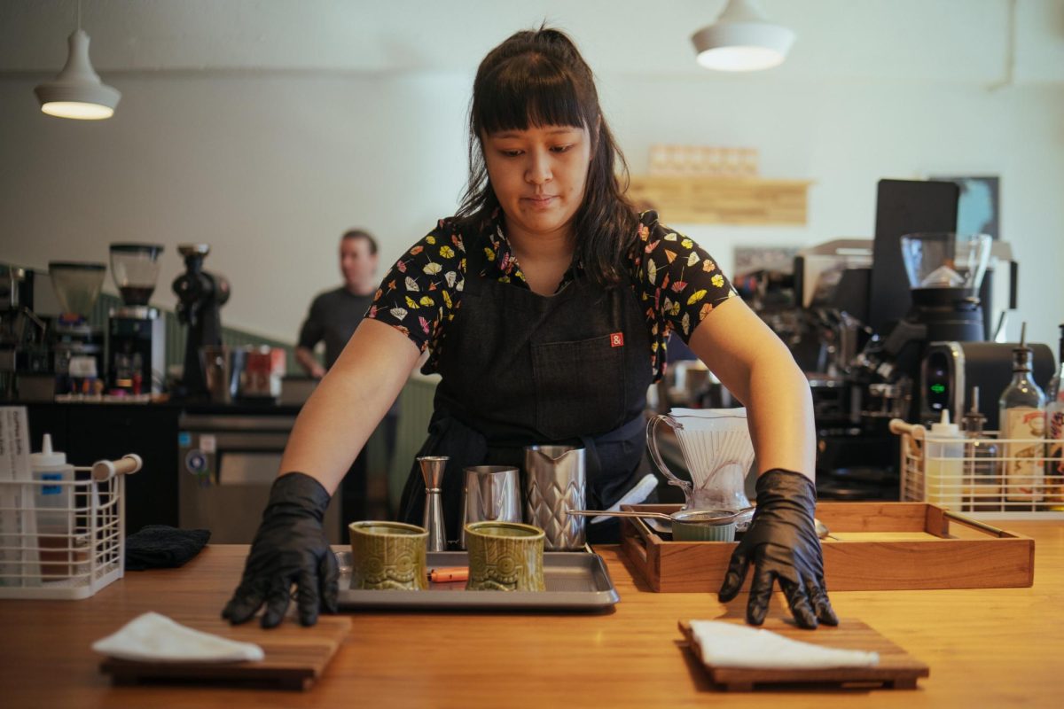 A competing barista sets the scene for her coffee creation.