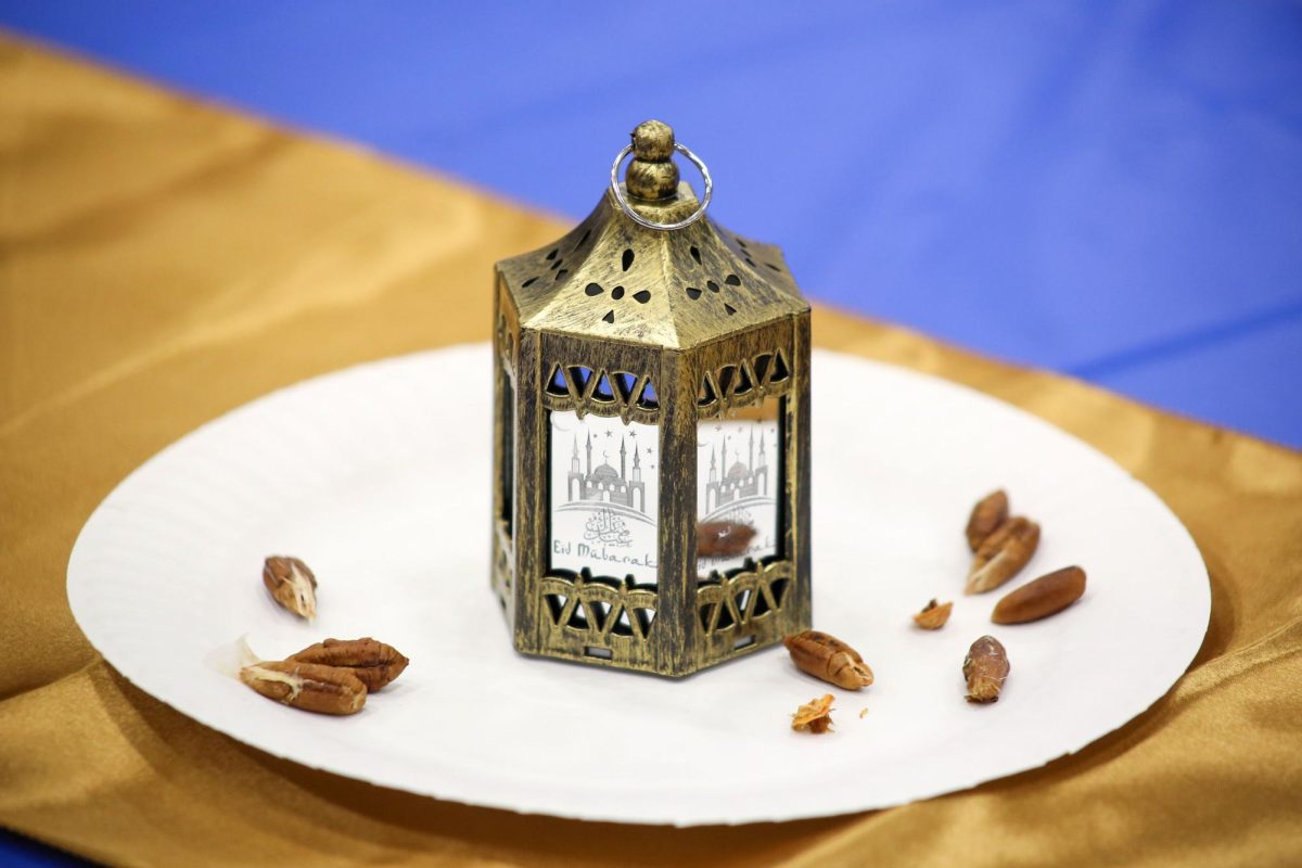 Date seeds and a miniature Eid lantern rest on a paper plate during Iftar in the University Student Center.