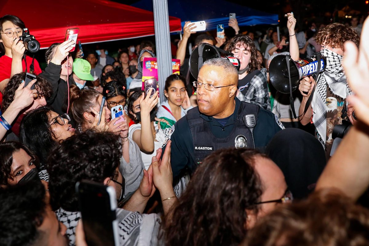 Protesters swarm a George Washington Police Department officer in University Yard on Sunday night. 