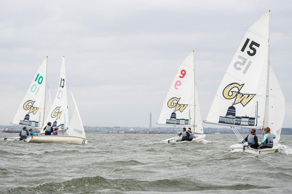 A cluster of GW sailboats glide across the Potomac River. 