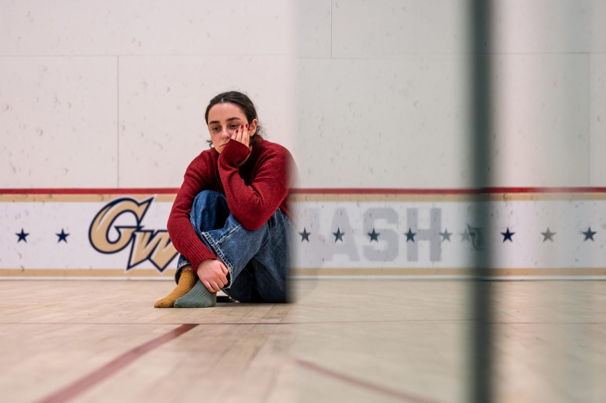 A student wallows in a squash court in the Lerner Health and Wellness Center.