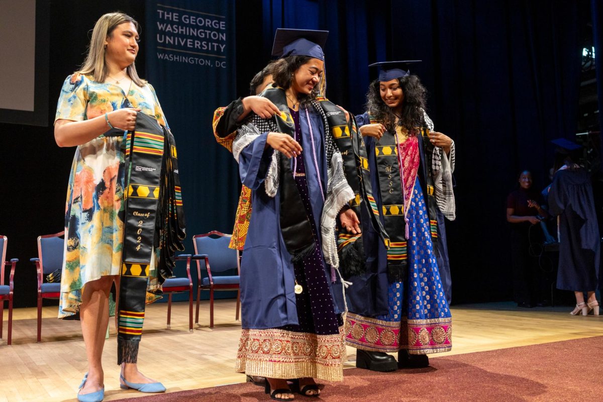 A graduate receives their stole at the Multicultural Student Services Center Commencement ceremony.